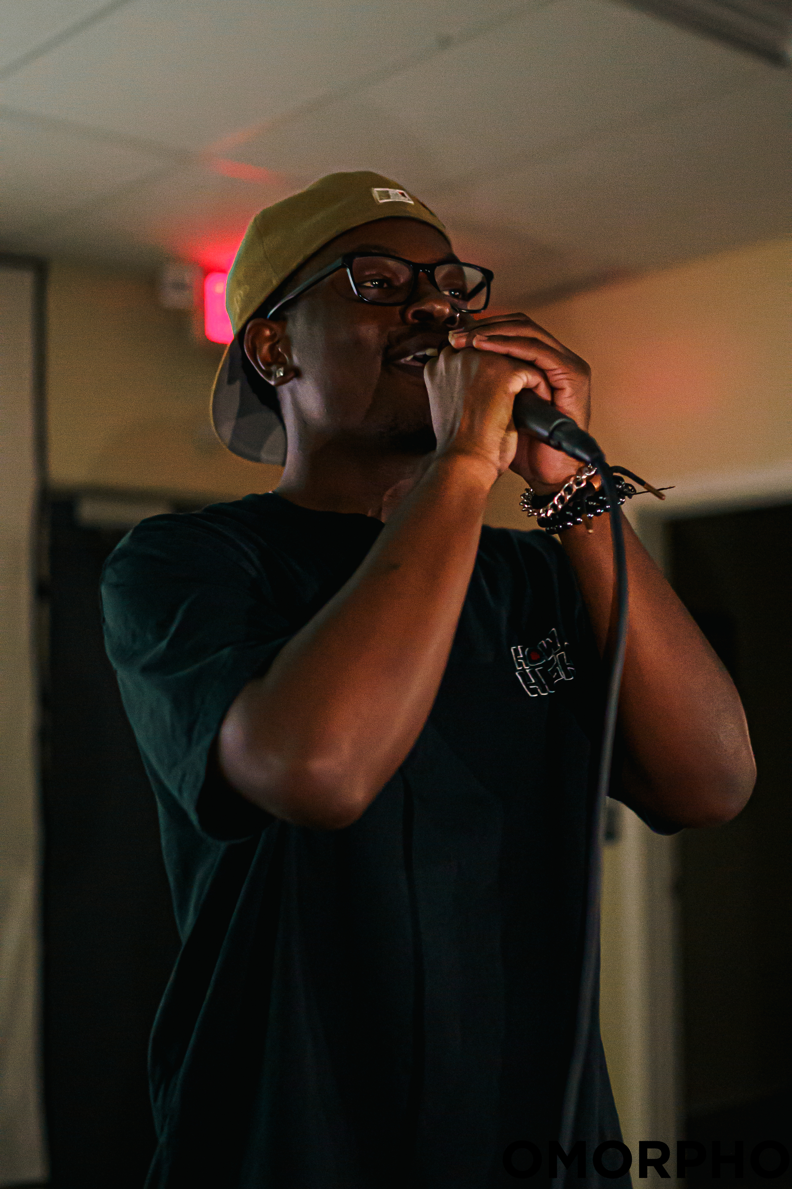 KWEZZ holding a microphone during a performance