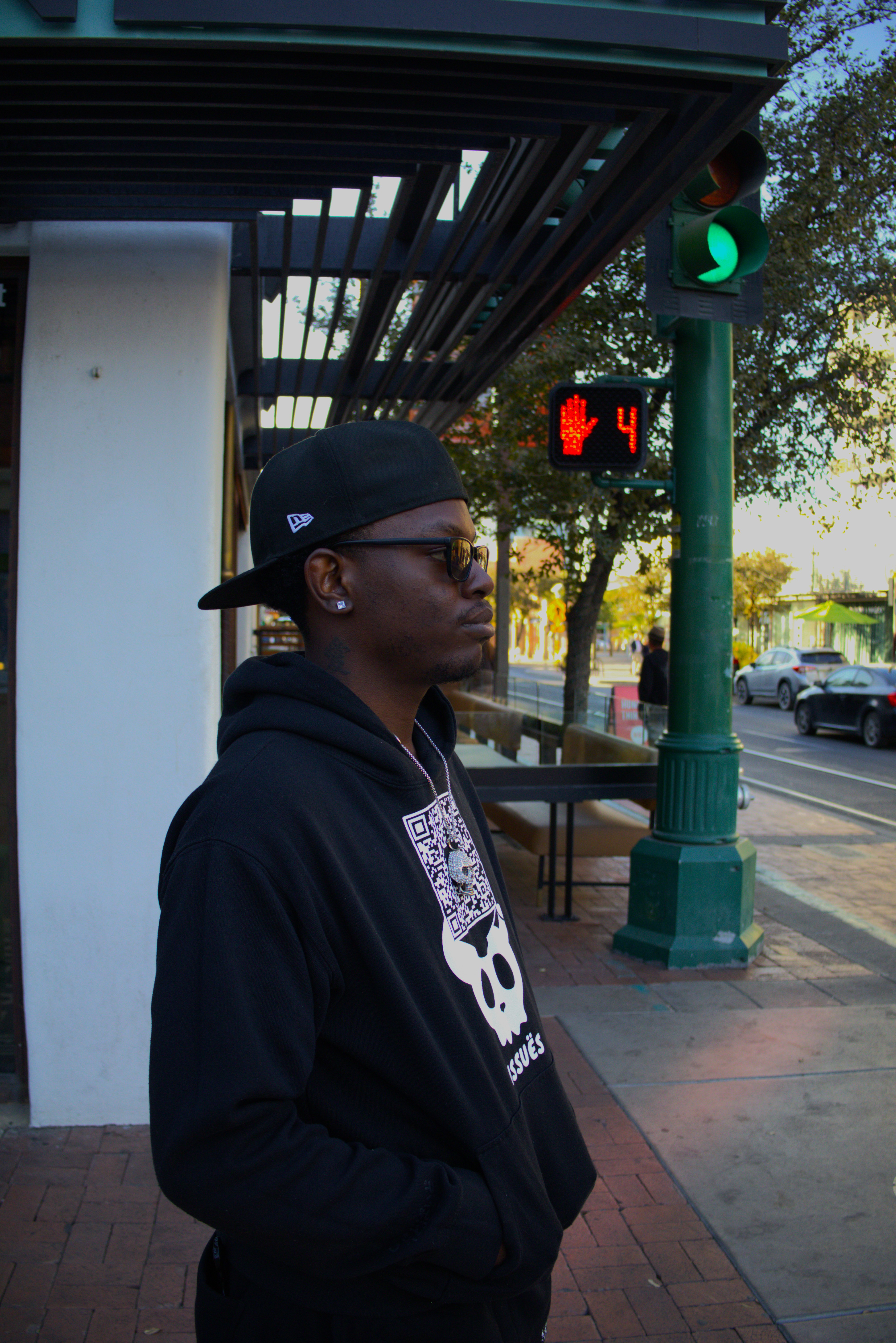KWEZZ standing beside a street crossing